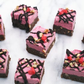 Raw Chocolate Raspberry Brownies made up of a raw chocolate brownie base, filled with delicious nuts, and topped with creamy raw raspberry cheesecake. Yummy in the tummy! #raw #vegan #brownies #brownie #raspberry #chocolate #nuts