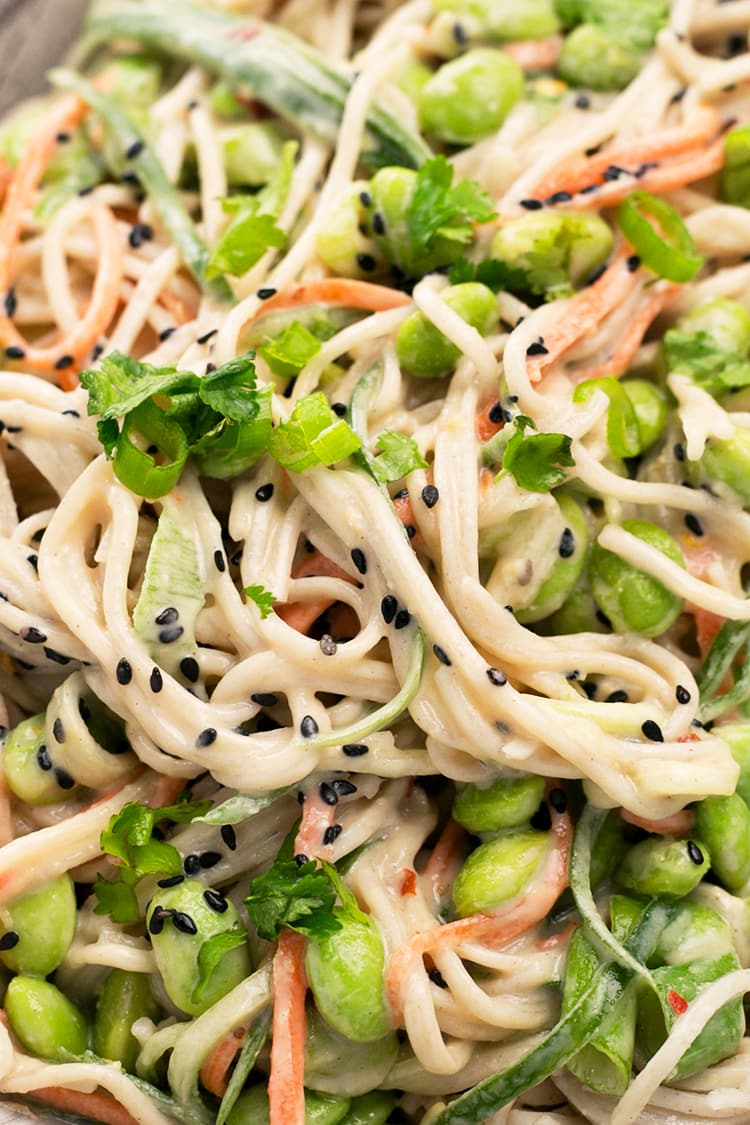 Japanese inspired Soba Noodles with edamame, carrot and cucumber - tossed in a delicious Miso Tahini Dressing. Vegan and Gluten Free. #vegan #japanese #asian #soba #healthy #foodporn #tahini #ginger #noodles
