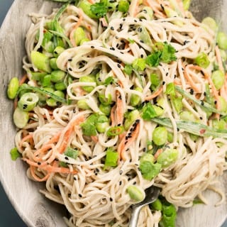 Japanese inspired Soba Noodles with edamame, carrot and cucumber - tossed in a delicious Miso Tahini Dressing. Vegan and Gluten Free. #vegan #japanese #asian #soba #healthy #foodporn #tahini #ginger #noodles