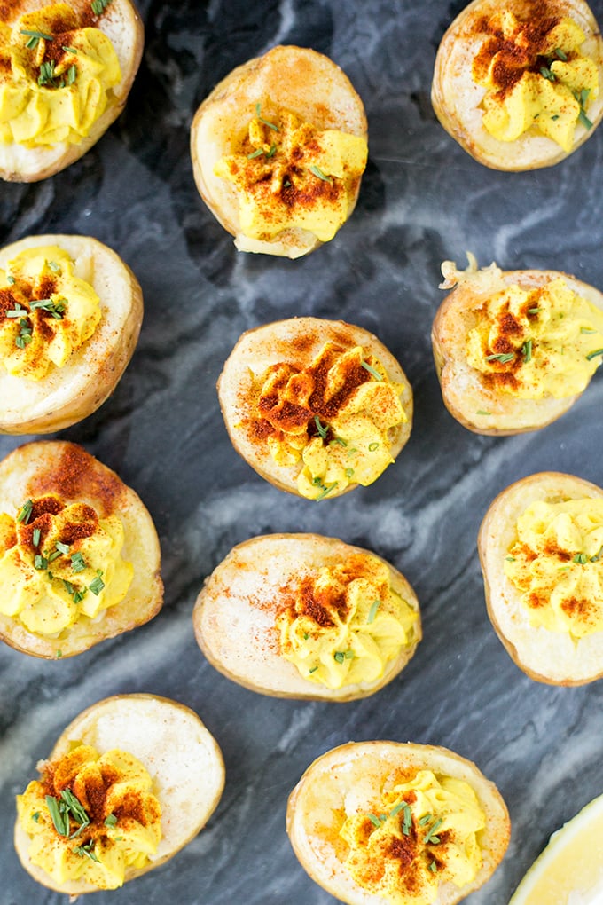 Vegan Deviled Potato Bites - A vegan version of Deviled Eggs. Homemade Hummus piped into Roasted Potatoes. #vegan #healthy #glutenfree #deviledeggs #simple #cheap