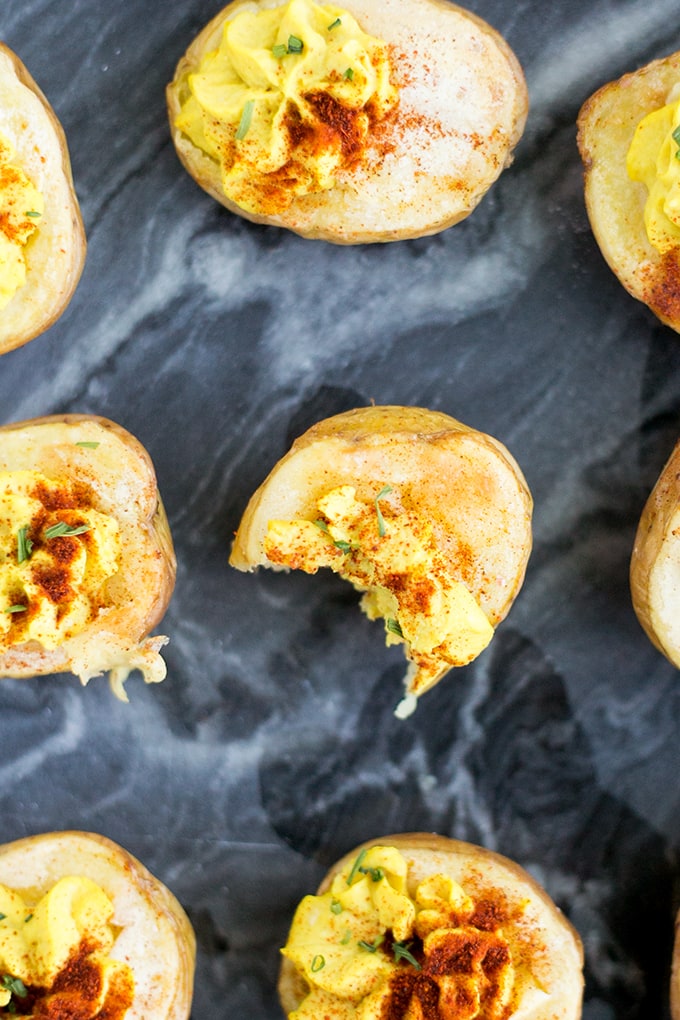 Vegan Deviled Potato Bites - A vegan version of Deviled Eggs. Homemade Hummus piped into Roasted Potatoes. #vegan #healthy #glutenfree #deviledeggs #simple #cheap