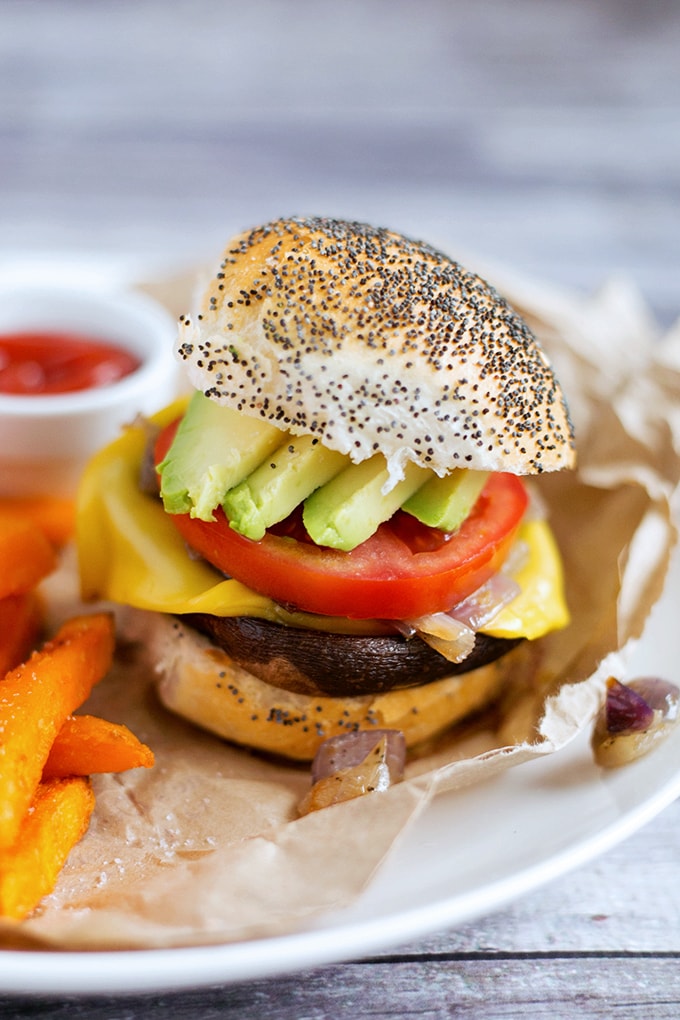 Simple Vegan Portobello Mushroom Burgers with Sweet Onions, Avocado, Tomato and Vegan Cheese. Inexpensive, Simple To Make And Full Of Flavor. #vegan #mushroom #burgers #veganburger #simple #portobellomushroom #recipes 