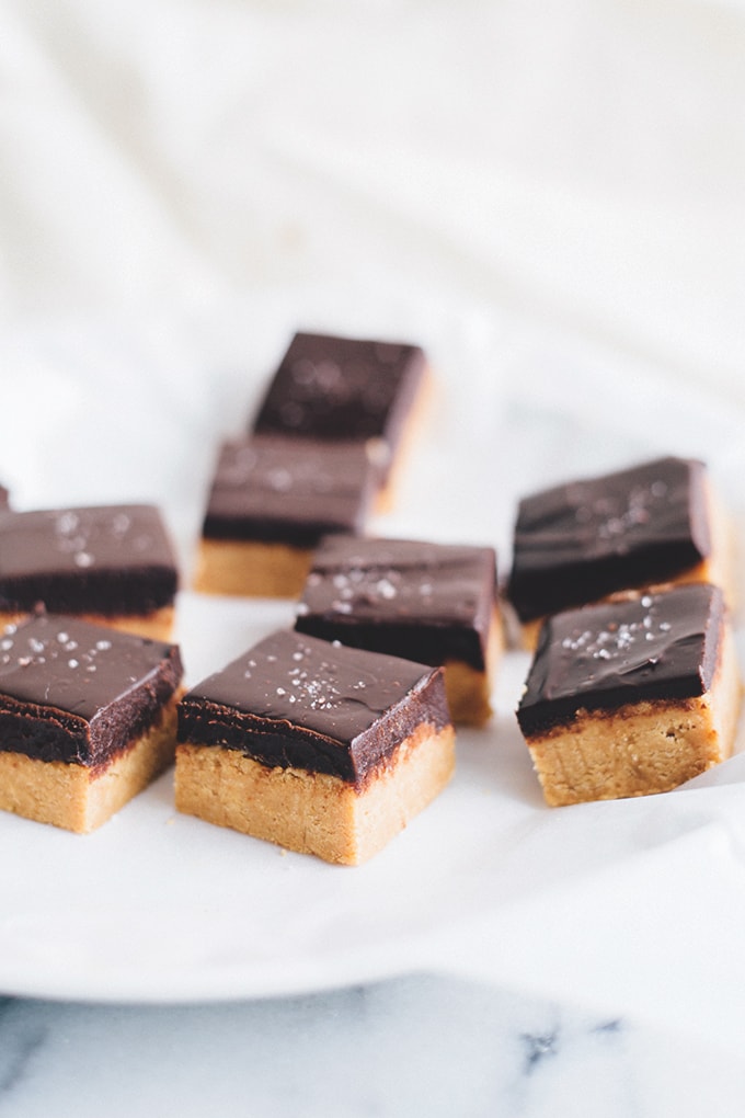 No Bake Vegan Chocolate Peanut Butter Slice - A delicious, rich and creamy treat that doesn't require any baking. Peanut Butter Base and silky Chocolate Ganache Topping. #vegan #vegetarian #dairyfree #peanutbutter #chocolate #bars #easy #simple