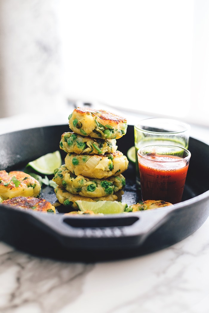 Vegan Aloo Tikki - Spiced Potato Patties with Homemade Coriander Chutney. A Vegan and Gluten Free version of a delicious Indian street snack. #vegan #alootikki #samosa #vegansamosa #indian #potato #healthy #quick #spices #peas #veganrecipes