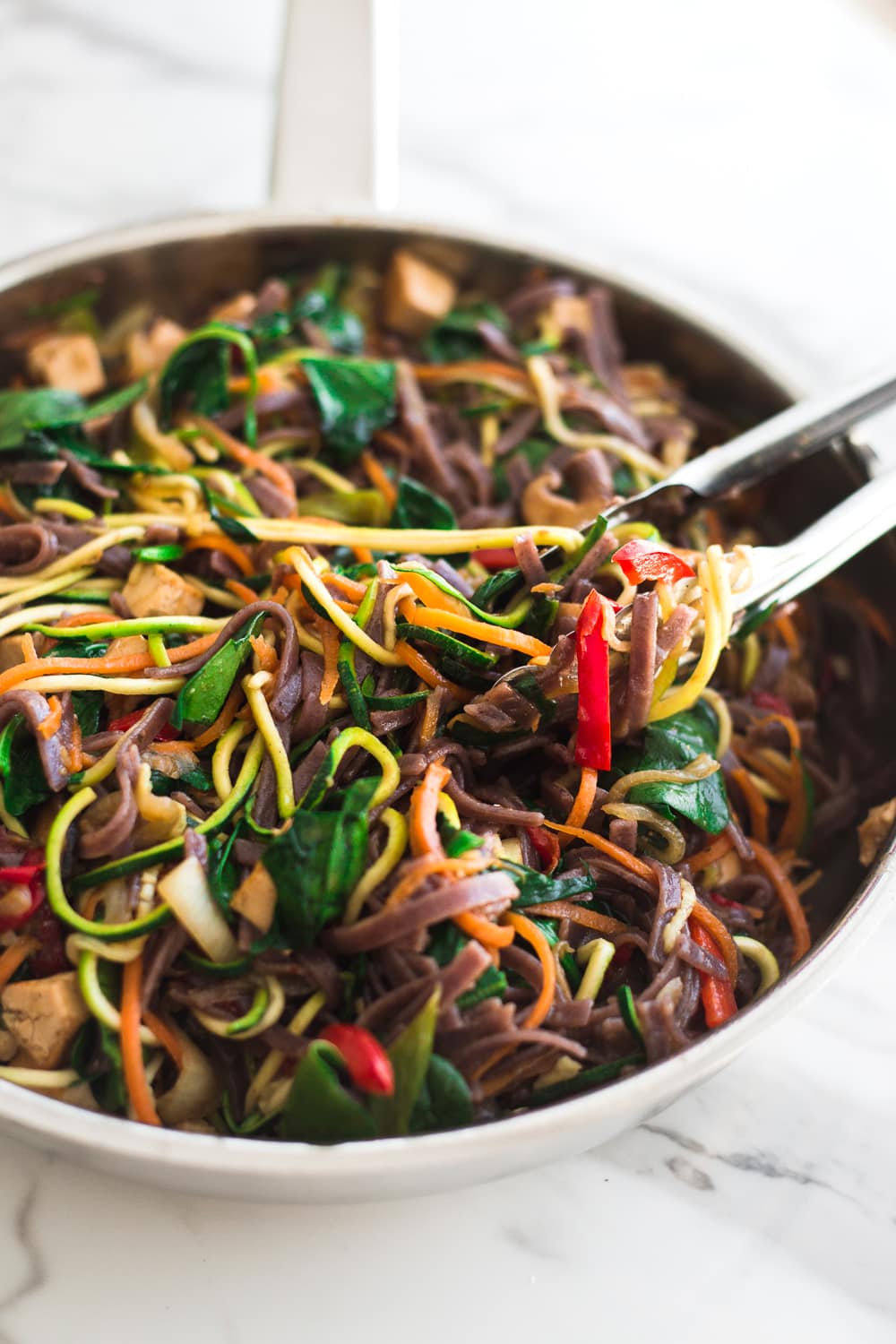 Healthy Vegan Korean Japchae Noodles - A Simple Dish loaded with Vegetables and Zucchini Noodles that is ready in under 30 minutes. #vegan #japchae #korean #noodles #recipe #asian #quick