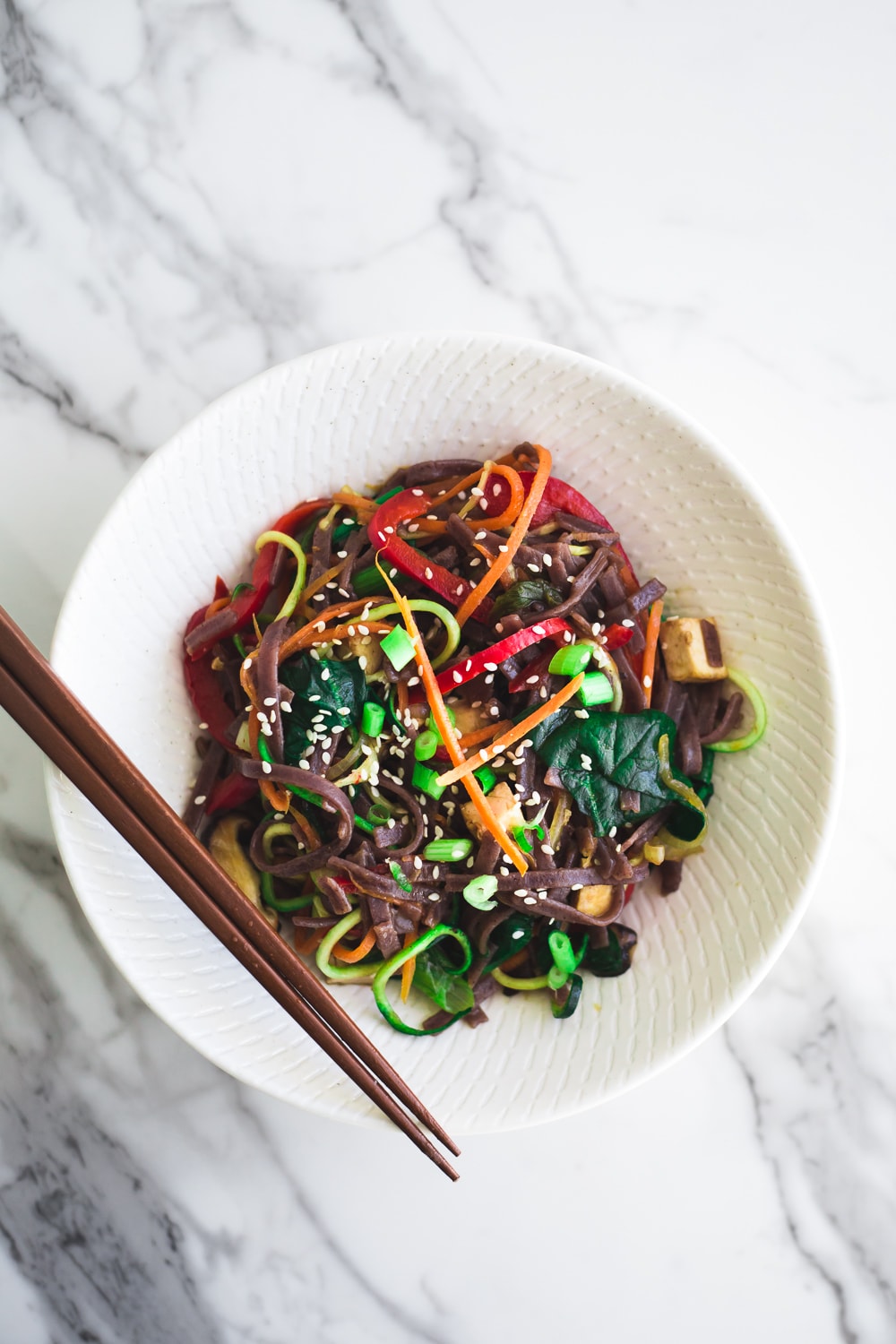 Healthy Vegan Korean Japchae Noodles - A Simple Dish loaded with Vegetables and Zucchini Noodles that is ready in under 30 minutes. #vegan #japchae #korean #noodles #recipe #asian #quick