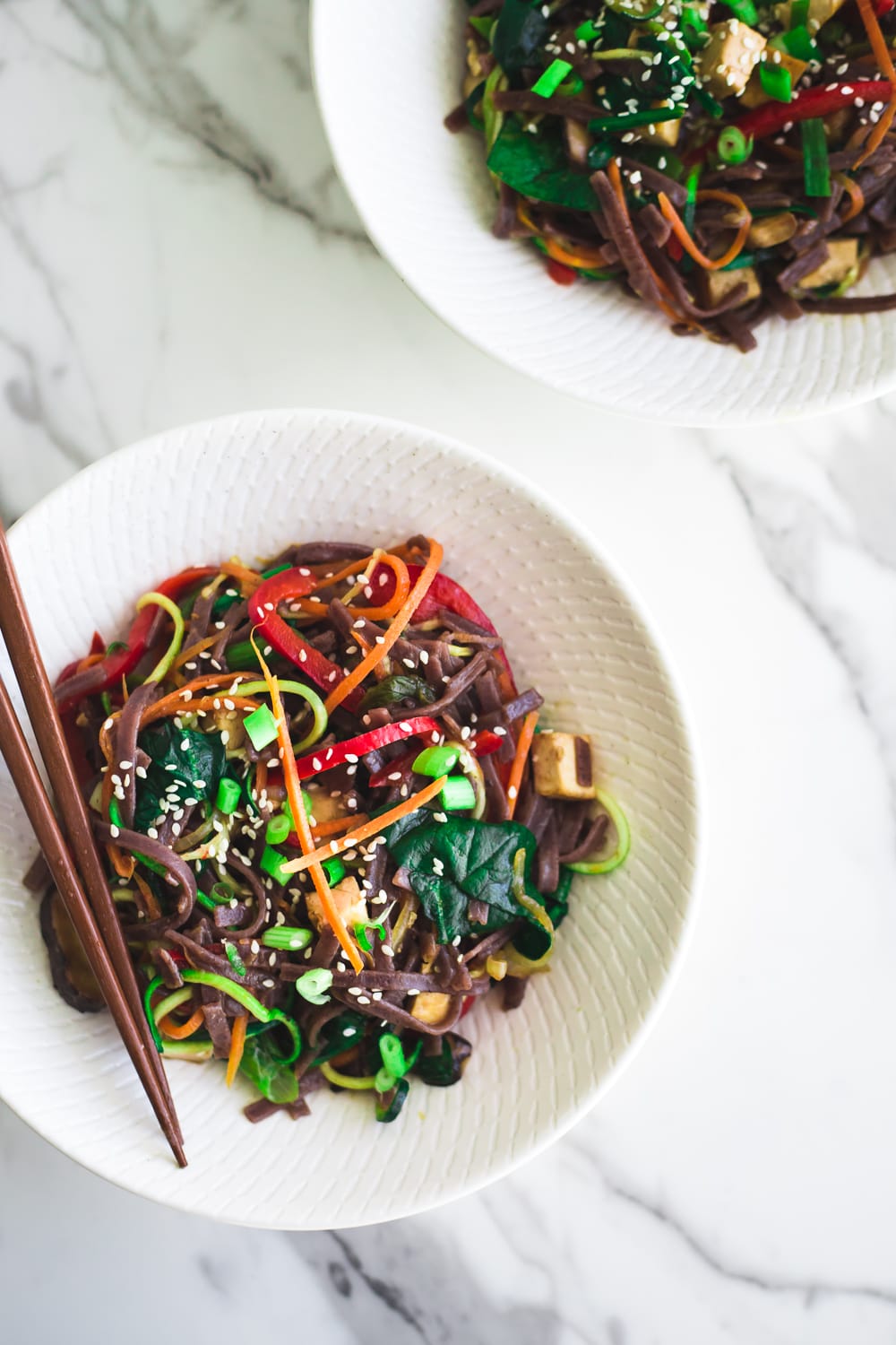 Healthy Vegan Korean Japchae Noodles - A Simple Dish loaded with Vegetables and Zucchini Noodles that is ready in under 30 minutes. #vegan #japchae #korean #noodles #recipe #asian #quick