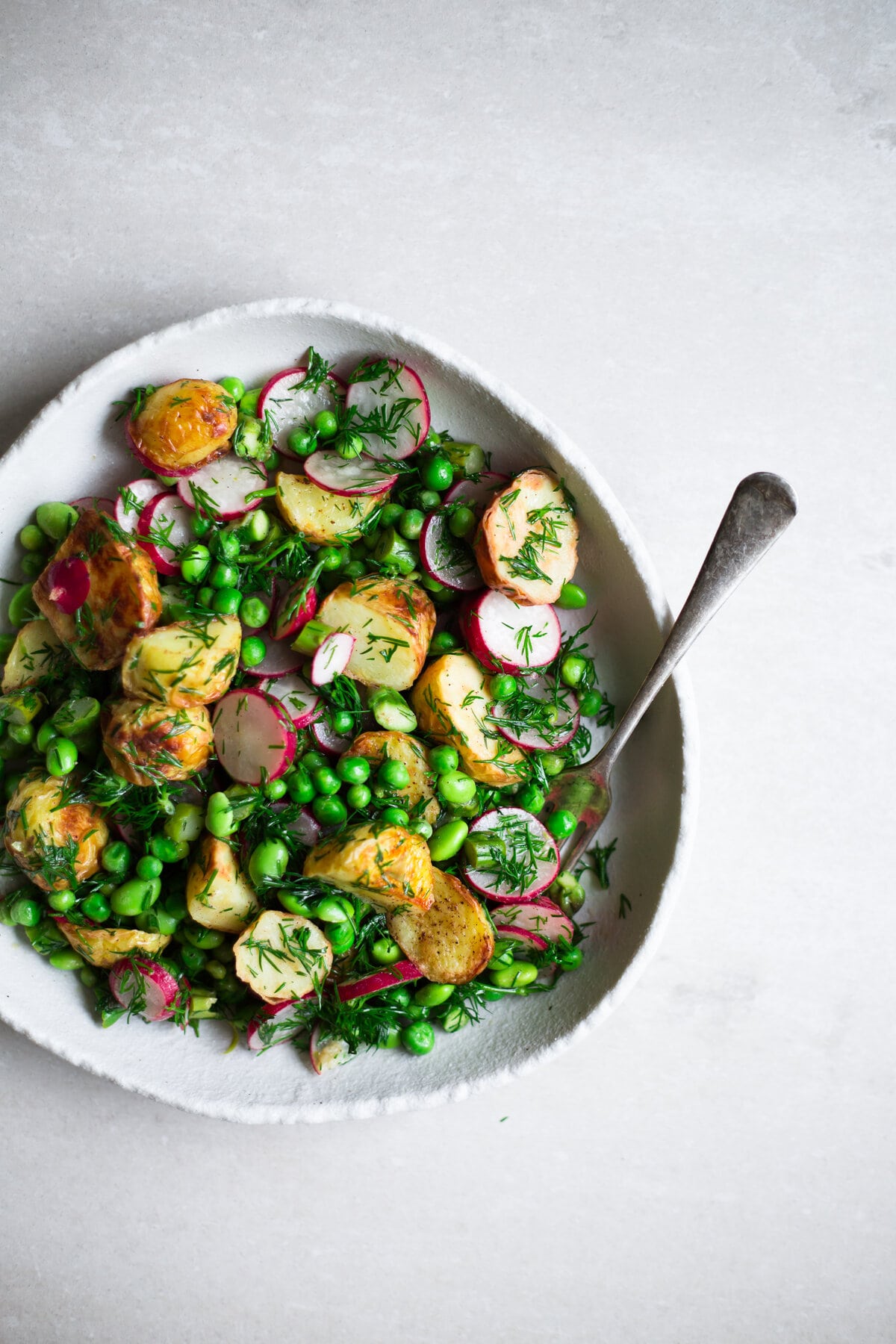 Vegan Spring Potato Salad - A Delicious, Healthy Salad that is low in Fat and packed full of goodness. Asparagus, Potatoes, Green Peas, Edamame, Dill and a Tangy Dressing. Ready in under 30 minutes. Vegan/Gluten Free. #vegan #potatosalad #glutenfree #healthy 