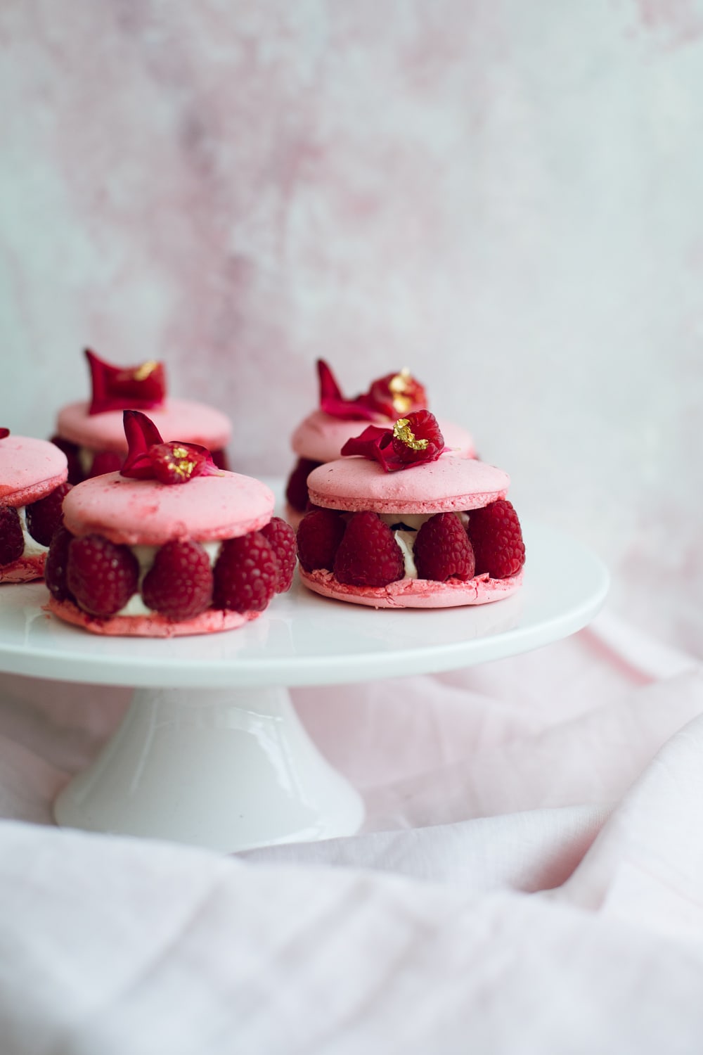 The Vegan Ispahan, made with Italian Meringue Vegan Macarons. Rose Shell, White Chocolate Rose Cream, Lychees and Raspberries. Gluten Free. #glutenfree #veganmacaron #ispahan #vegan #macarons #aquafaba #lychee #rose #raspberry