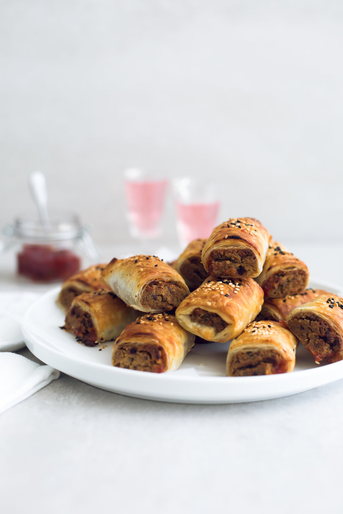 Delicious Vegan Tofu Sausage Rolls - Tofu and Nut Sausage Mince encased in golden and flaky Puff Pastry, served with Tomato Sauce. Perfect for parties and picnics. #vegan #tofu #sausagerolls #vegansausagerolls #simple #delicious #puffpastry #nuts 