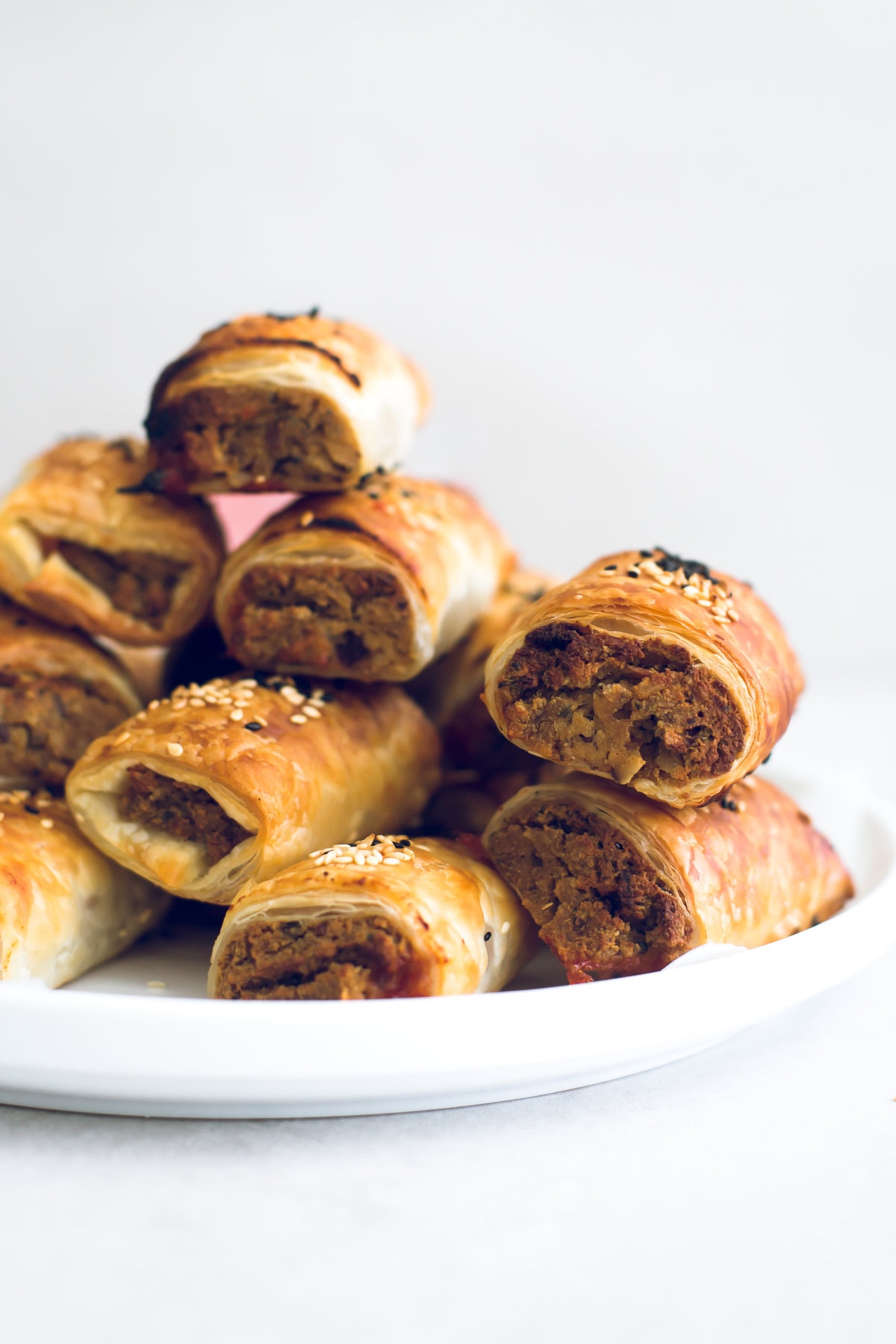 Delicious Vegan Tofu Sausage Rolls - Tofu and Nut Sausage Mince encased in golden and flaky Puff Pastry, served with Tomato Sauce. Perfect for parties and picnics. #vegan #tofu #sausagerolls #vegansausagerolls #simple #delicious #puffpastry #nuts 