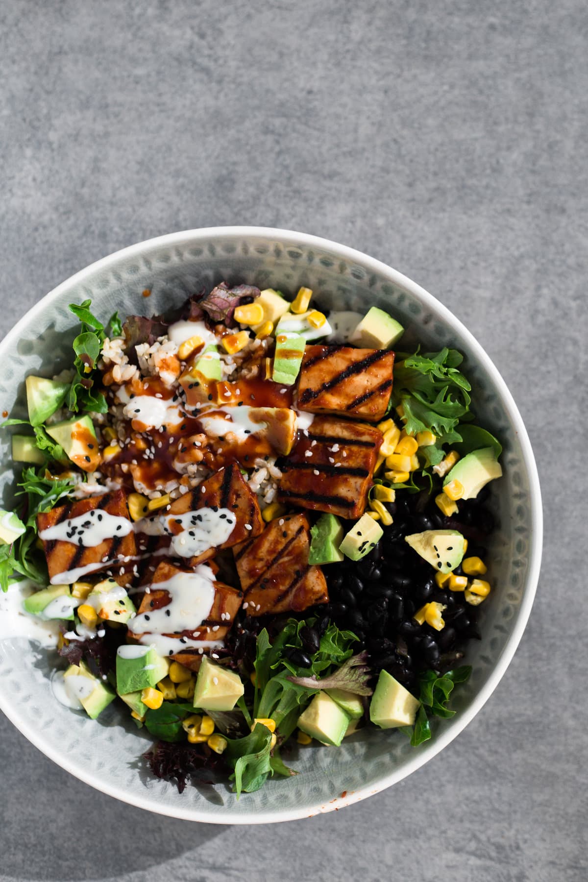 A delicious Vegan Barbecue Bowl loaded with Brown Rice, Avocado, Corn, Black Beans and Smokey Barbecue Tofu. Healthy, delicious, simple. #vegan #bbq #tofu #barbecue #mexican #burritobowl #salad #delicious #healthy #yum