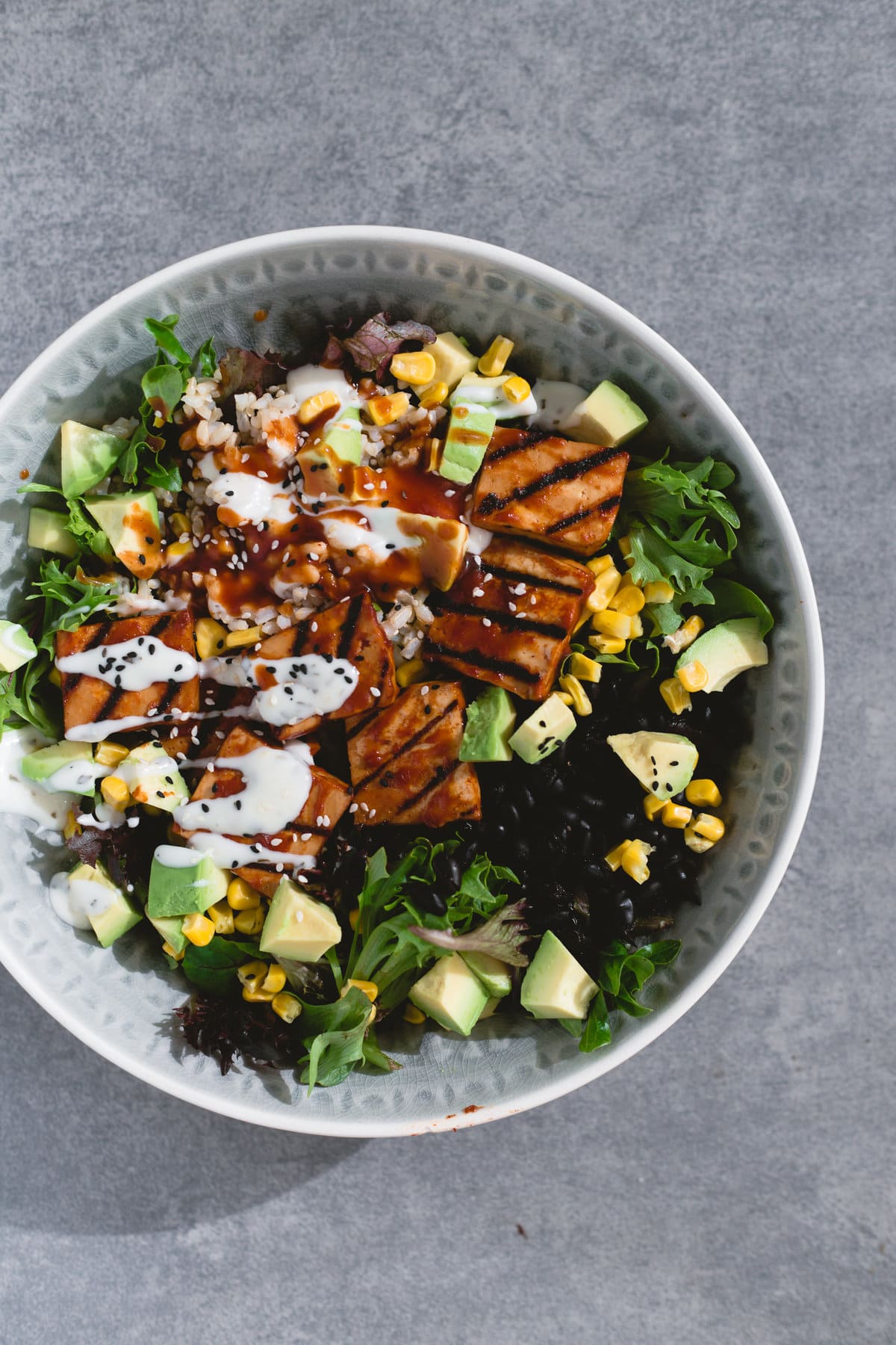 A delicious Vegan Barbecue Bowl loaded with Brown Rice, Avocado, Corn, Black Beans and Smokey Barbecue Tofu. Healthy, delicious, simple. #vegan #bbq #tofu #barbecue #mexican #burritobowl #salad #delicious #healthy #yum