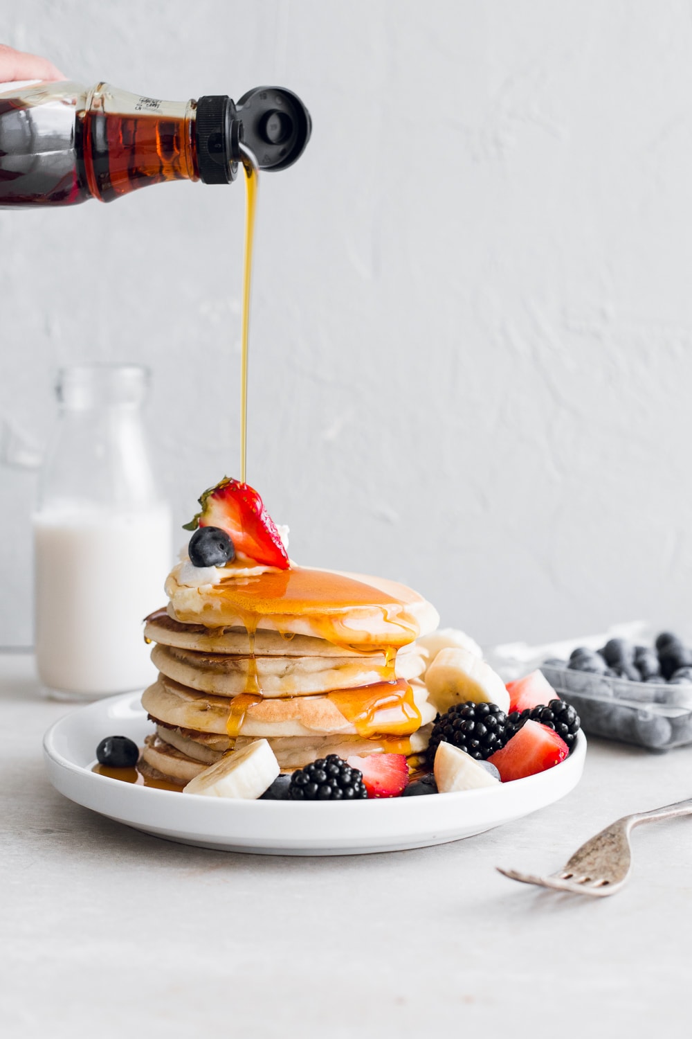 A quick and simple recipe for the Easiest Vegan Pancakes. Light and fluffy, ready in under 10 minutes and made with everyday pantry ingredients. #vegan #pancakes #simple #easy #children #kids #dairyfree #10minutes #morning #breakfast #brunch #eggless #eggfree