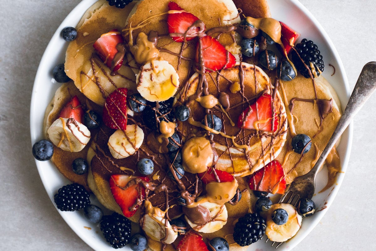 A quick and simple recipe for the Easiest Vegan Pancakes. Light and fluffy, ready in under 10 minutes and made with everyday pantry ingredients. #vegan #pancakes #simple #easy #children #kids #dairyfree #10minutes #morning #breakfast #brunch #eggless #eggfree