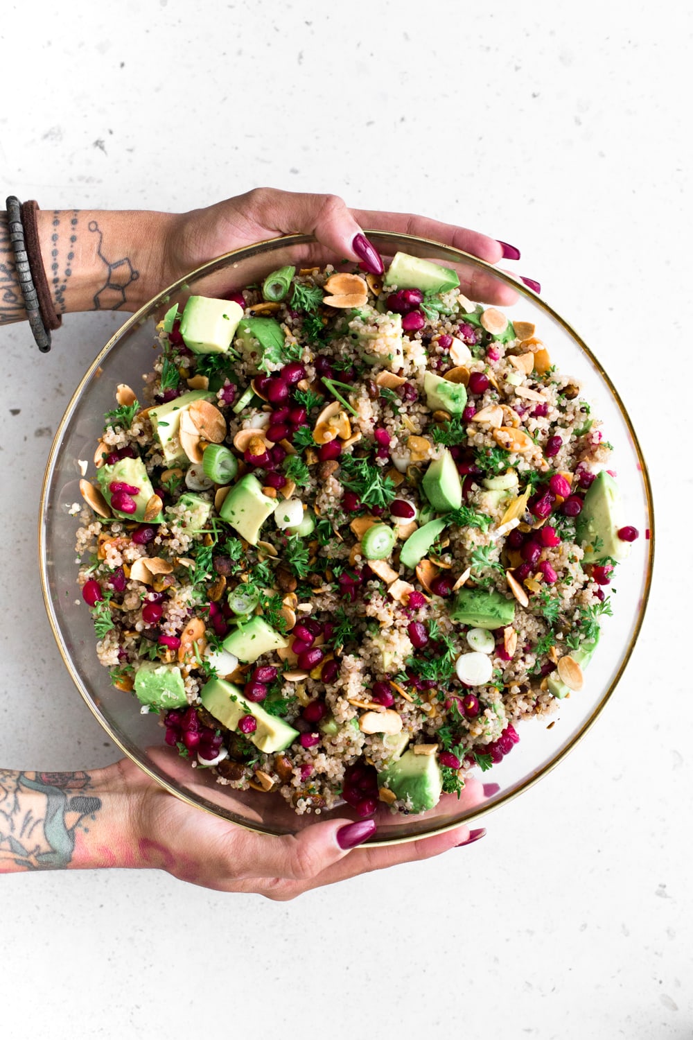 A delicious Vegan Quinoa Crunch Salad studded with toasted Almond, Pistachio and Pomegranate. Perfect for a healthy lunch or as a potluck dish! #quinoa #christmas #holidays #pomegranate #orange #healthy #glutenfree #salad #avocado #pistachio #almond 