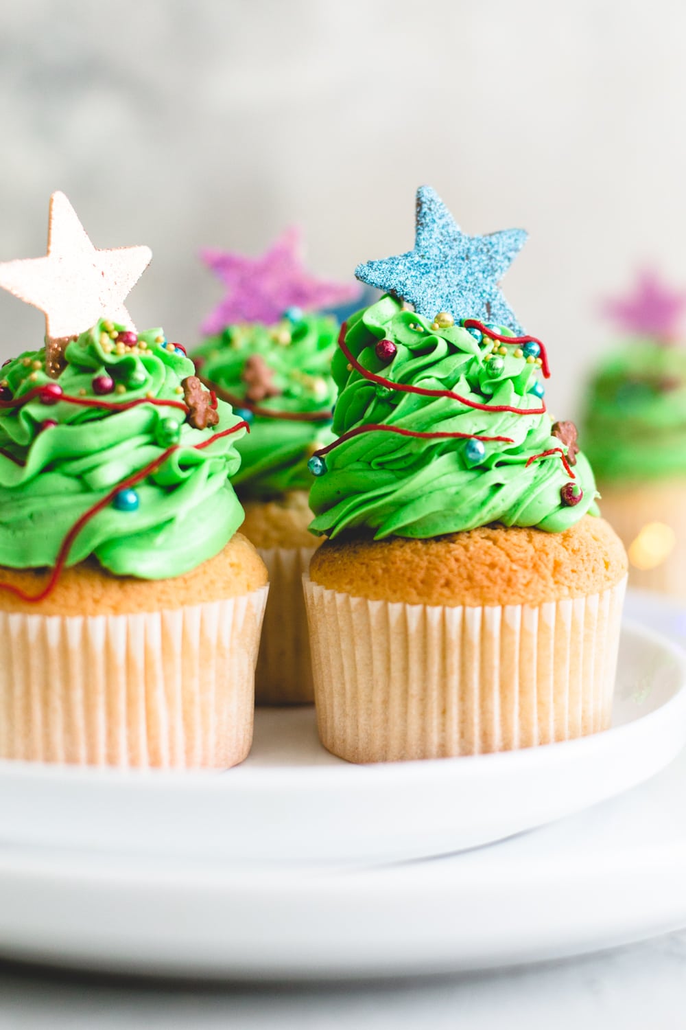 Tender and delicious Vegan Vanilla Cupcakes that everyone will love. Iced with Vanilla Buttercream Frosting and perfect for birthdays. #vegan #cupcakes #dessert #cake #vegancupcakes #vanilla #christmas #xmas #holidays #baking #veganbaking