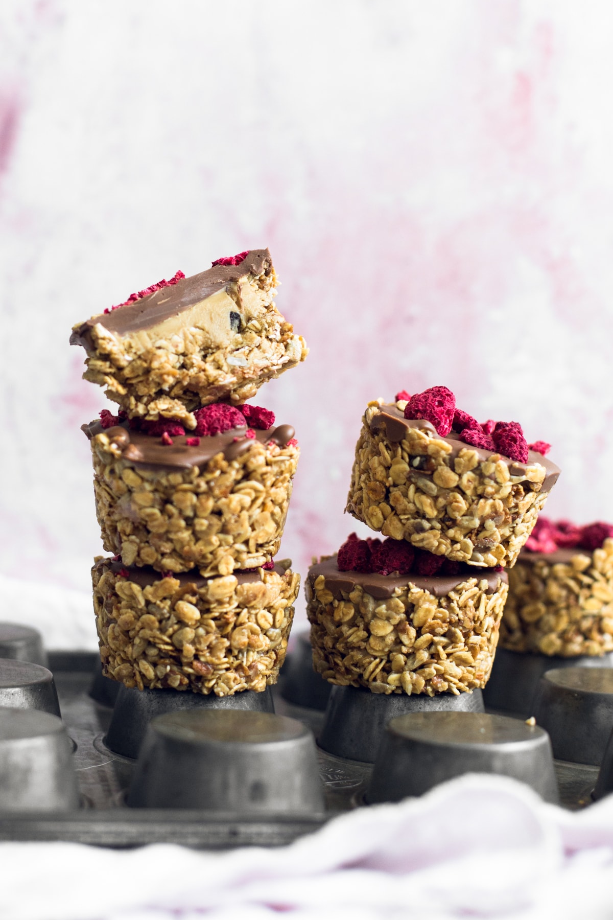 Simple No-Bake Vegan Granola Cups filled with Nut Butter of your choice and topped off with Chocolate. Read in under an hour. #vegan #granola #oats #chocolate #snacks #healthy #peanutbutter #nobake #slice #fridge #veganrecipes