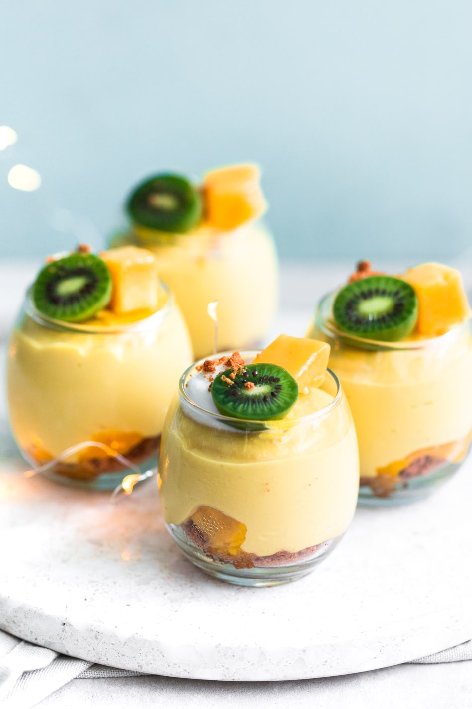 A delicious and fresh No-Bake Vegan Mango Cheesecake that tastes like summer in a cup. Refined Sugar Free, Dairy-Free and simple to make. #vegan #mango #cheesecake #dessert #dairyfree #mangocream #pudding #vegancheesecake #veganmangodesserts #dessert #crueltyfree #simple #vitamix 