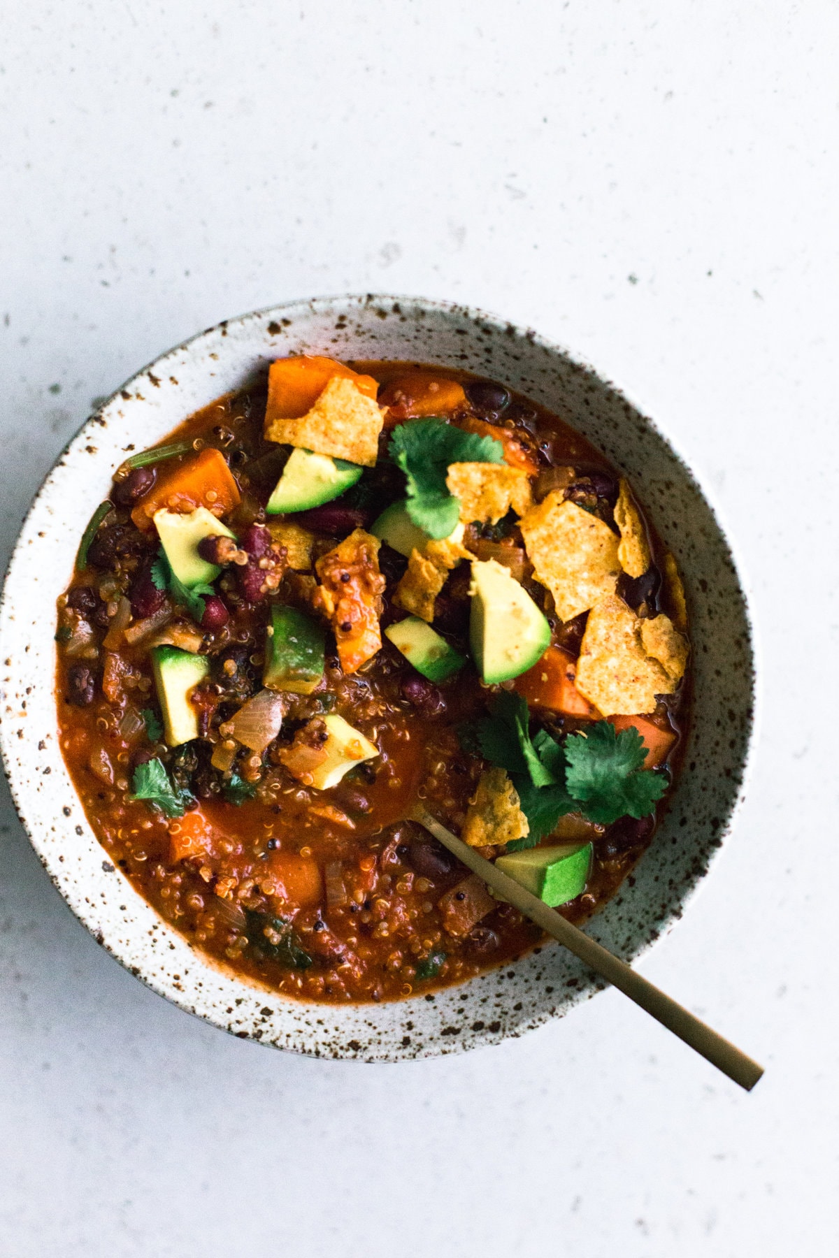 A delicious and hearty one pot Vegan Sweet Potato and Quinoa Chili. Ready in under one hour, Gluten Free, Low in Fat and made with common pantry staples. #vegan #chili #quinoa #healthy #simple #stew #hearty #veganchili #vegetarian #tomato #beans #onepot #mexican #soup #tortilla 