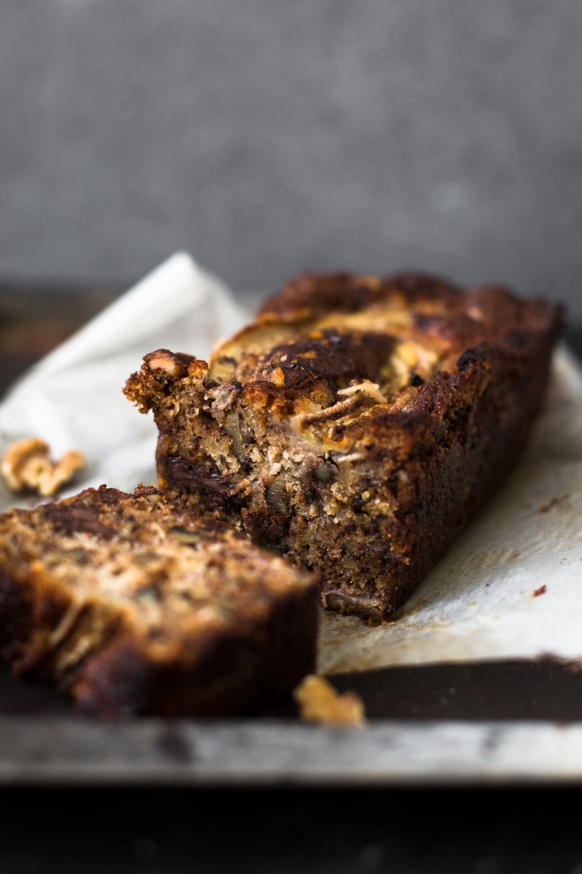 A delicious Vegan Banana Bread recipe loaded with Walnuts, Dark Chocolate and a Brown Sugar Cinnamon Swirl in the middle. Ready in under 1 hour. #bananabread #vegan #cinnamon #cinnamonswirl #quickbread #bananamuffins #veganbaking #veganbananabread #easy #simple #walnuts #chocolate #eggless #baking #dessert #breakfast