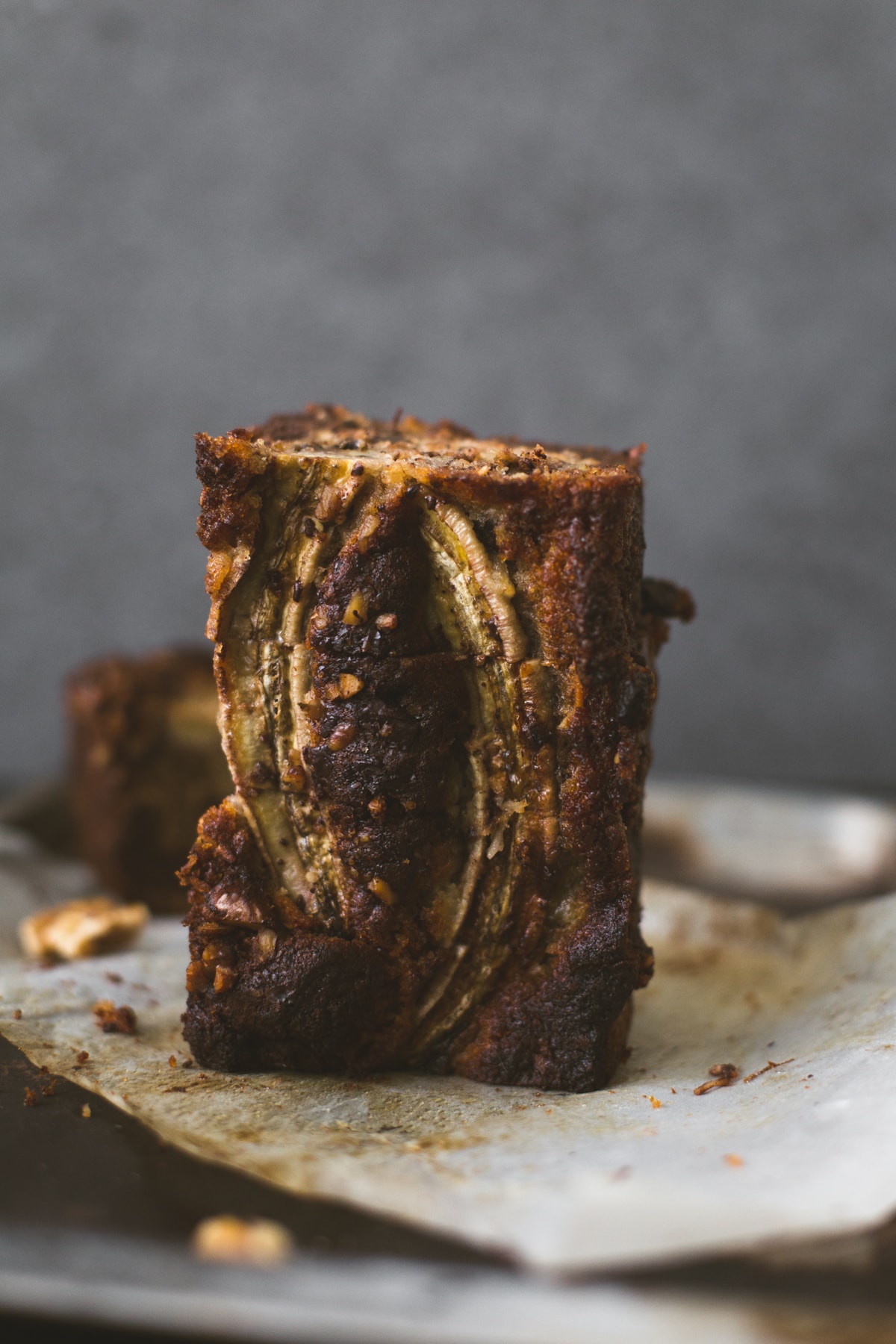 A delicious Vegan Banana Bread recipe loaded with Walnuts, Dark Chocolate and a Brown Sugar Cinnamon Swirl in the middle. Ready in under 1 hour. #bananabread #vegan #cinnamon #cinnamonswirl #quickbread #bananamuffins #veganbaking #veganbananabread #easy #simple #walnuts #chocolate #eggless #baking #dessert #breakfast