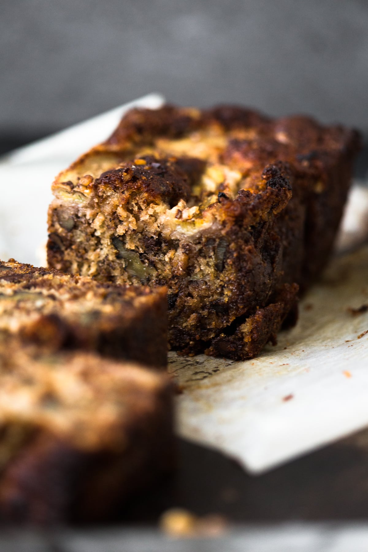 A delicious Vegan Banana Bread recipe loaded with Walnuts, Dark Chocolate and a Brown Sugar Cinnamon Swirl in the middle. Ready in under 1 hour. #bananabread #vegan #cinnamon #cinnamonswirl #quickbread #bananamuffins #veganbaking #veganbananabread #easy #simple #walnuts #chocolate #eggless #baking #dessert #breakfast