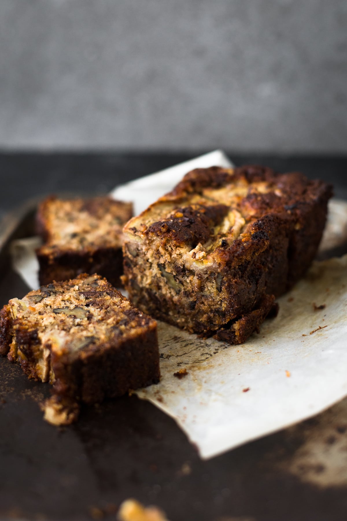 A delicious Vegan Banana Bread recipe loaded with Walnuts, Dark Chocolate and a Brown Sugar Cinnamon Swirl in the middle. Ready in under 1 hour. #bananabread #vegan #cinnamon #cinnamonswirl #quickbread #bananamuffins #veganbaking #veganbananabread #easy #simple #walnuts #chocolate #eggless #baking #dessert #breakfast