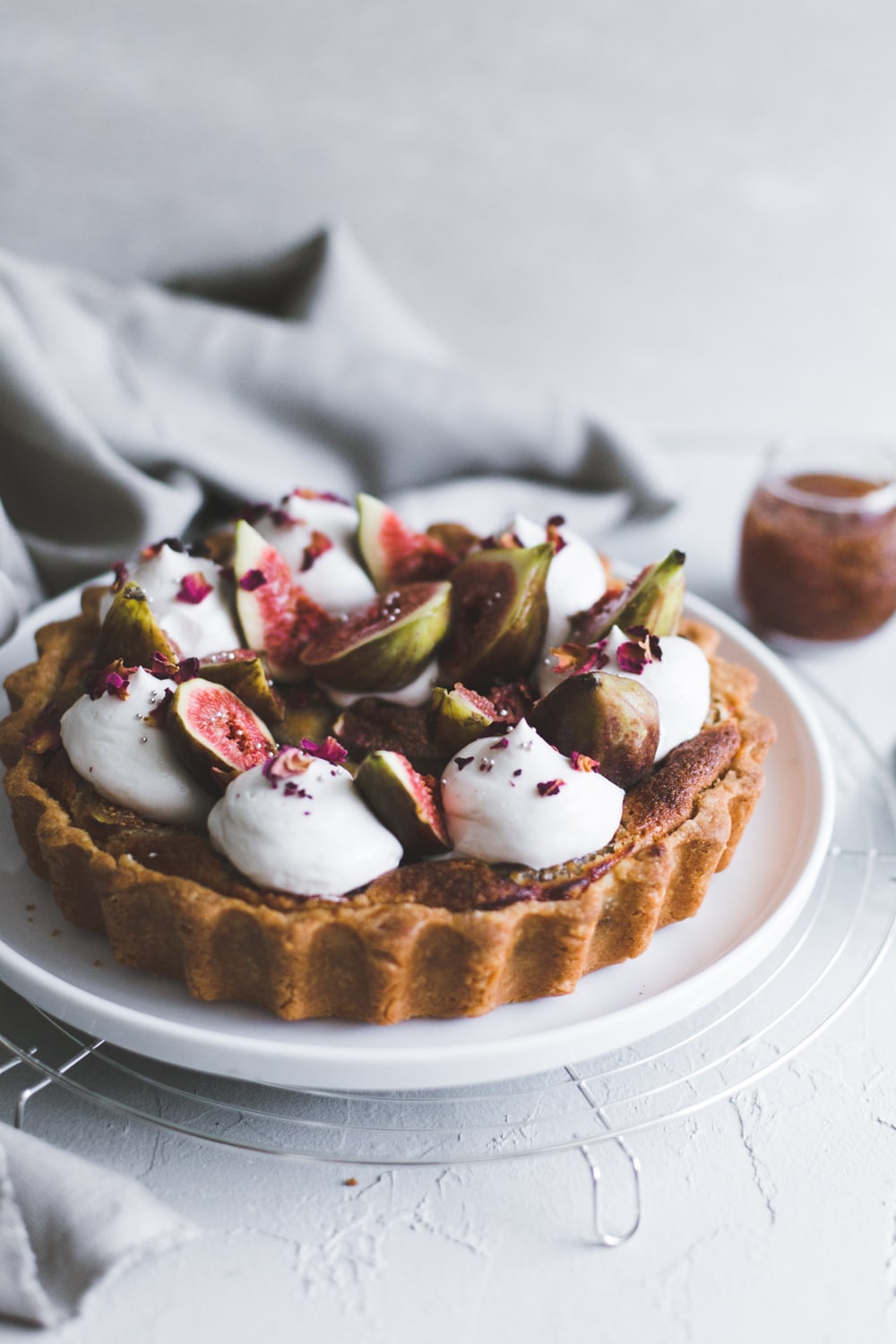 A delicious Vegan Fig Tart with a sweet pastry crust filled with Fig Jam, Vegan Almond Frangipane and topped with Vegan Whipped Cream. #fig #tart #vegan #almond #frangipane #fruittart #dairyfree #simple #easy #plantbased #almondpaste